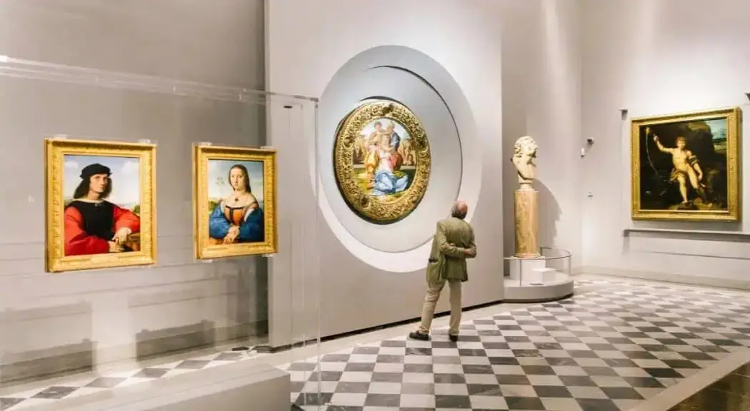 A gentleman looking at the artworks displayed at the Uffizi Gallery