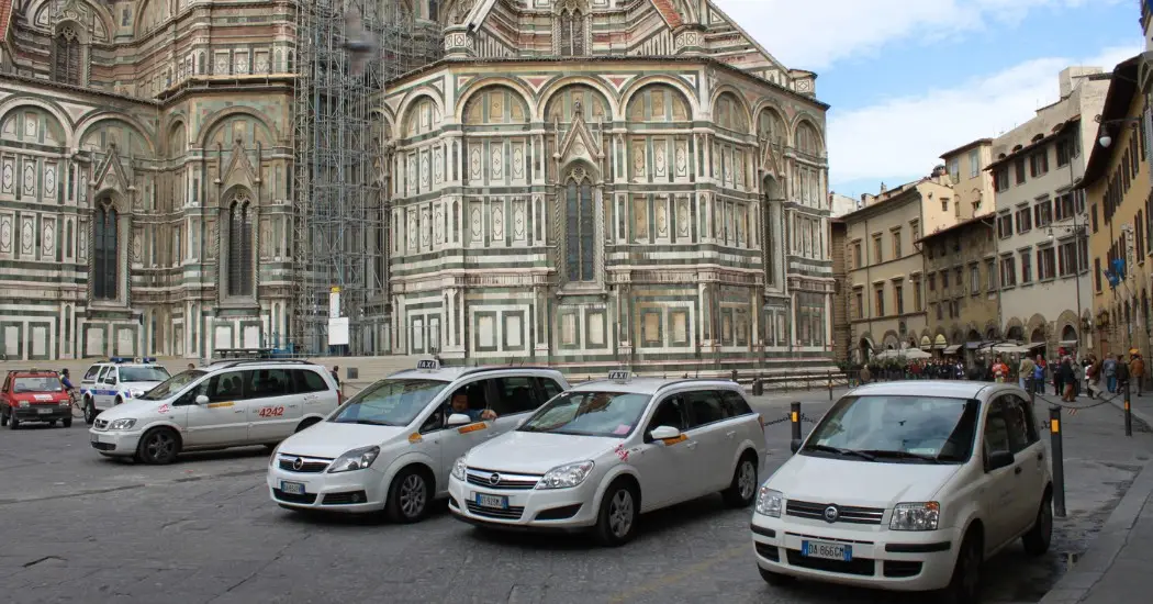 A Few white taxis of Florence waiting on the streets